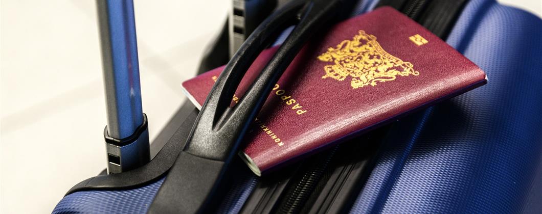 Close Up Image Of A Blue Travel Suitcase With Red Passport.