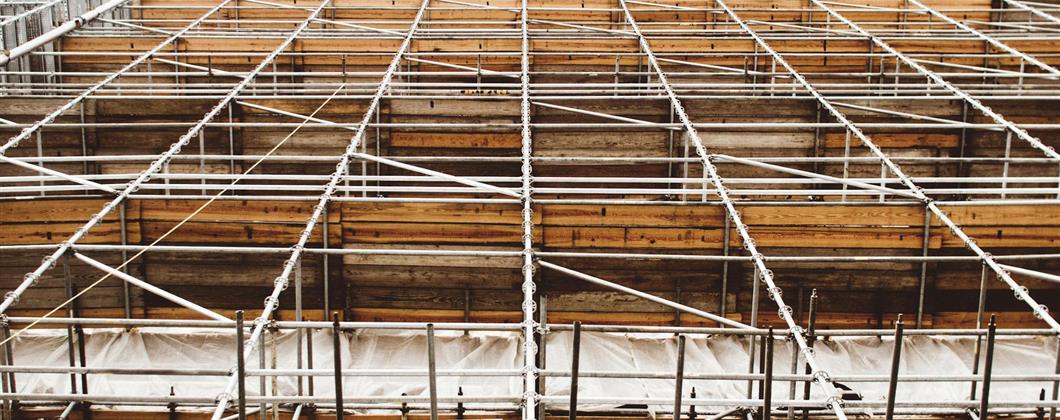 Scaffolding covering the façade of a commercial construction project. 